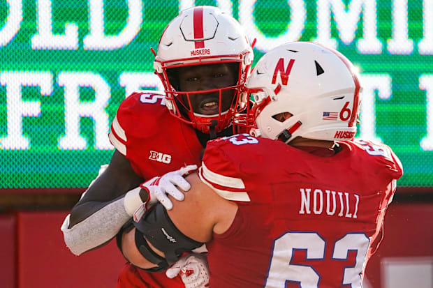 Nebraska Cornhuskers wide receiver Malachi Coleman (15) and offensive lineman Nouredin Nouili (63)