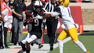 Oct 15, 2016; Lubbock, TX, USA;  Texas Tech Red Raiders wide receiver Jonathan Giles (9) is tackled by West Virginia Mountaineers defensive back Antonio Crawford (1) at Jones AT&T Stadium. West Virginia defeated Texas Tech 48-17.  Mandatory Credit: Michael C. Johnson-Imagn Images