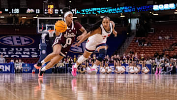 Mar 6, 2025; Greenville, SC, USA; Mississippi State Bulldogs guard Denim DeShields (0) drives by Ole Miss Rebels guard KK Deans (1) during the first half at Bon Secours Wellness Arena. Mandatory Credit: Scott Kinser-Imagn Images
