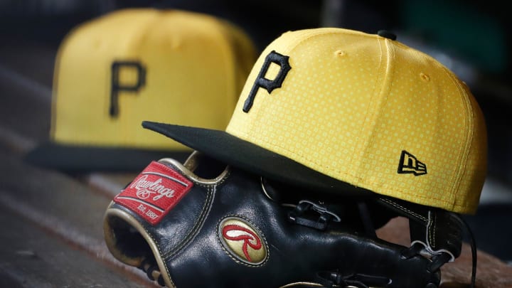 Sep 16, 2023; Pittsburgh, Pennsylvania, USA;  Pittsburgh Pirates hats and gloves in the dugout against the New York Yankees during the sixth inning at PNC Park. Mandatory Credit: Charles LeClaire-USA TODAY Sports