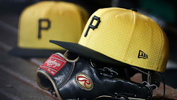 Sep 16, 2023; Pittsburgh, Pennsylvania, USA;  Pittsburgh Pirates hats and gloves in the dugout against the New York Yankees during the sixth inning at PNC Park. Mandatory Credit: Charles LeClaire-Imagn Images