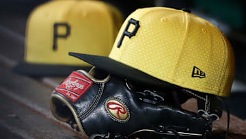 Sep 16, 2023; Pittsburgh, Pennsylvania, USA;  Pittsburgh Pirates hats and gloves in the dugout against the New York Yankees during the sixth inning at PNC Park. Mandatory Credit: Charles LeClaire-Imagn Images