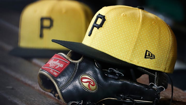 Sep 16, 2023; Pittsburgh, Pennsylvania, USA;  Pittsburgh Pirates hats and gloves in the dugout against the New York Yankees during the sixth inning at PNC Park. Mandatory Credit: Charles LeClaire-Imagn Images