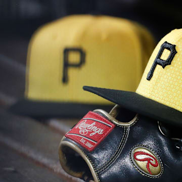 Sep 16, 2023; Pittsburgh, Pennsylvania, USA;  Pittsburgh Pirates hats and gloves in the dugout against the New York Yankees during the sixth inning at PNC Park. Mandatory Credit: Charles LeClaire-Imagn Images