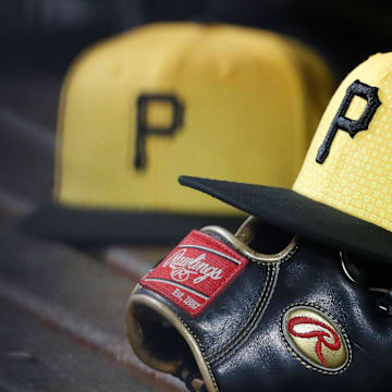 Sep 16, 2023; Pittsburgh, Pennsylvania, USA;  Pittsburgh Pirates hats and gloves in the dugout against the New York Yankees during the sixth inning at PNC Park. Mandatory Credit: Charles LeClaire-Imagn Images