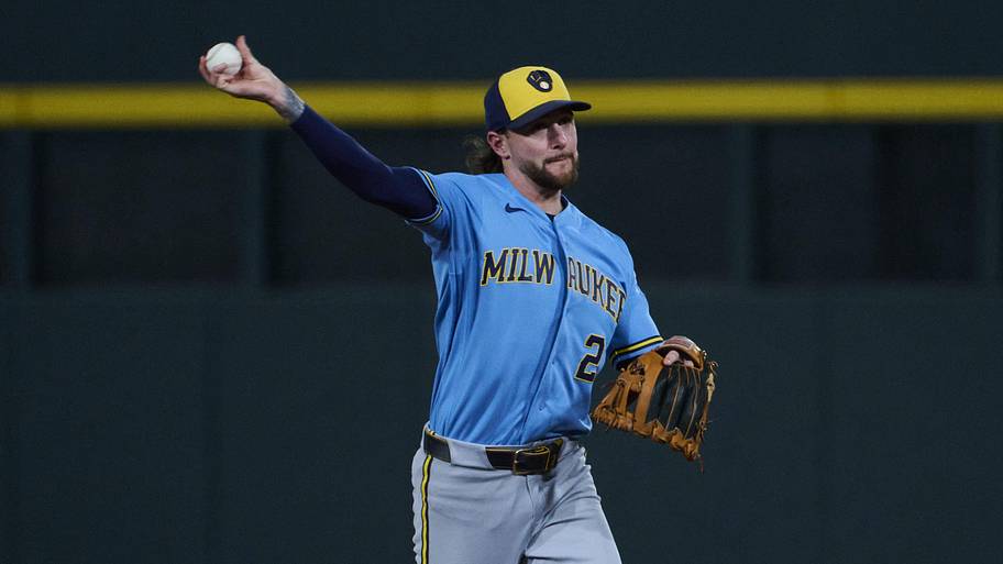 Milwaukee Brewers second baseman Brice Turang throws to first base