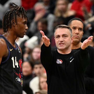 fJan 21, 2025; Toronto, Ontario, CAN;  Toronto Raptors head coach Darko Rajakovic speaks with guard Ja'Kobe Walter (14) as assistant coach Jama Mahlalela looks on in the second half against the Orlando Magic at Scotiabank Arena. Mandatory Credit: Dan Hamilton-Imagn Images