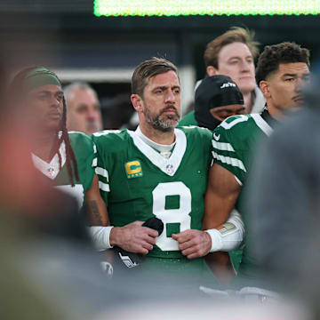 Jan 5, 2025; East Rutherford, New Jersey, USA; New York Jets quarterback Aaron Rodgers (8) stands with teammates during the national anthem before the game against the Miami Dolphins at MetLife Stadium. Mandatory Credit: Vincent Carchietta-Imagn Images