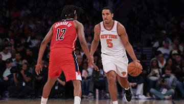 Oct 13, 2025; New York, New York, USA; New York Knicks guard Malcolm Brogdon (5) dribbles against Washington Wizards guard Tre Johnson (12)during the first half at Madison Square Garden. Mandatory Credit: Vincent Carchietta-Imagn Images