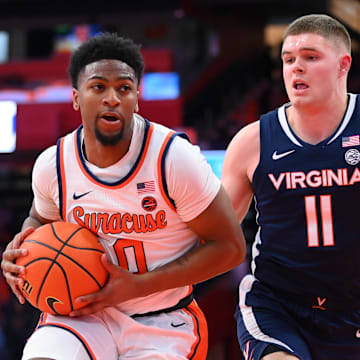 Mar 8, 2025; Syracuse, New York, USA; Syracuse Orange guard Kyle Cuffe Jr. (0) drives against Virginia Cavaliers guard Isaac McKneely (11) during the first half at the JMA Wireless Dome. Mandatory Credit: Rich Barnes-Imagn Images