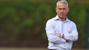 Chicago Cubs President of Baseball Operations watches practice at Wrigley Field.