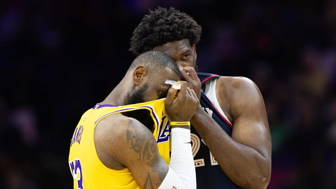 Nov 27, 2023; Philadelphia, Pennsylvania, USA: Philadelphia 76ers center Joel Embiid (21) talks with Los Angeles Lakers forward LeBron James (23) during the second quarter at Wells Fargo Center. Mandatory Credit: Bill Streicher-Imagn Images