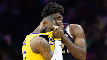 Nov 27, 2023; Philadelphia, Pennsylvania, USA: Philadelphia 76ers center Joel Embiid (21) talks with Los Angeles Lakers forward LeBron James (23) during the second quarter at Wells Fargo Center. Mandatory Credit: Bill Streicher-Imagn Images