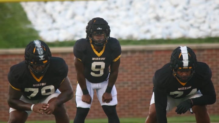 Aug 17, 2024; Columbia, Missouri USA; Missouri Tigers running back Marcus Carroll (9, center) lines up behind offensive tackle Armand Membou (79, left) and offensive guard Cam'Ron Johnson (right, 74) during the team's practice at Faurot Field. 