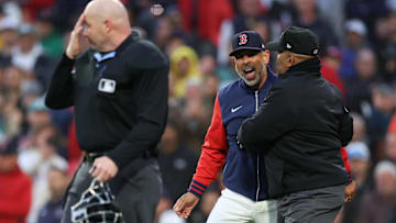 May 20, 2025; Boston, Massachusetts, USA; Boston Red Sox manager Alex Cora (13) yells at home plate umpire Mike Estabrook (83) during the third inning against the New York Mets at Fenway Park.