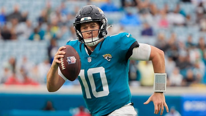 Jacksonville Jaguars quarterback Mac Jones runs with the ball. Jacksonville Jaguars quarterback Mac Jones runs with the ball.