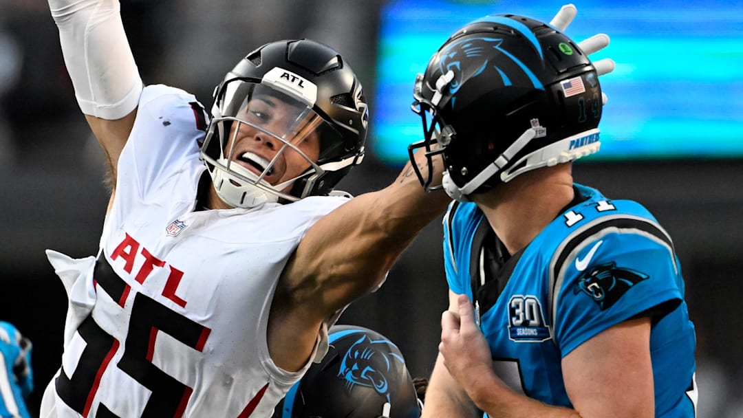 Oct 13, 2024; Charlotte, North Carolina, USA; Carolina Panthers quarterback Andy Dalton (14) passes the ball as Atlanta Falcons linebacker Kaden Elliss (55) pressures in the second quarter at Bank of America Stadium. Mandatory Credit: Bob Donnan-Imagn Images