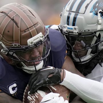 Green Bay Packers running back Josh Jacobs carries Carolina Panthers defenders.
