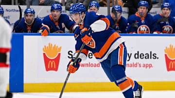 Jan 14, 2025; Elmont, New York, USA;  New York Islanders defenseman Noah Dobson (8) attempts a shot against the Ottawa Senators during the second period at UBS Arena. Mandatory Credit: Dennis Schneidler-Imagn Images