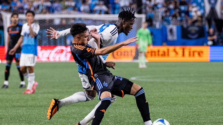 Jul 12, 2025; Charlotte, North Carolina, USA; New York City forward Agustín Ojeda (26) gets tangles with Charlotte FC forward Wilfried Zaha (10) during the second half at Bank of America Stadium. Jul 12, 2025; Charlotte, North Carolina, USA; New York City forward Agustín Ojeda (26) gets tangles with Charlotte FC forward Wilfried Zaha (10) during the second half at Bank of America Stadium.