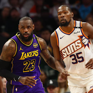 Oct 28, 2024; Phoenix, Arizona, USA; Los Angeles Lakers forward LeBron James (23) against Phoenix Suns forward Kevin Durant (35) at Footprint Center. Mandatory Credit: Mark J. Rebilas-Imagn Images