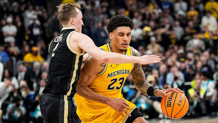 Michigan forward Yaxel Lendeborg (23) dribbles against Purdue guard Fletcher Loyer (2) during the second half of Big Ten Tournament final at United Center in Chicago on Sunday, March 15, 2026.