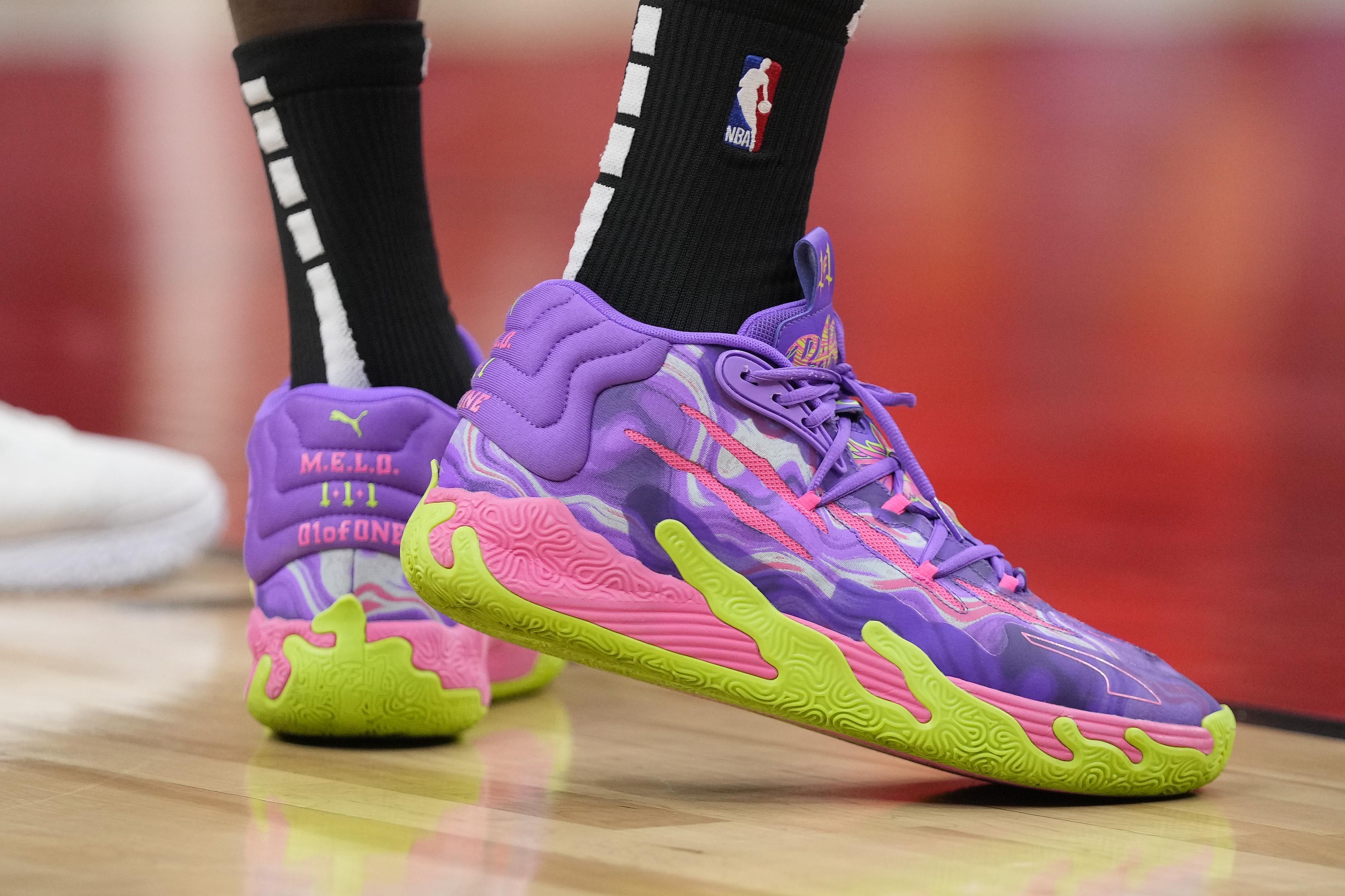 Toronto Raptors forward Chris Boucher's purple and green PUMA sneakers.