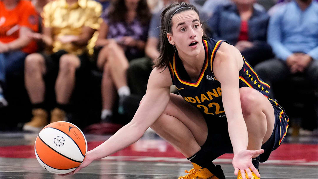 Indiana Fever guard Caitlin Clark kneels in frustration after a turnover call at Gainbridge Fieldhouse in Indianapolis.