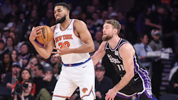 Jan 25, 2025; New York, New York, USA;  New York Knicks center Karl-Anthony Towns (32) secures the ball against Sacramento Kings forward Domantas Sabonis (11) in the third quarter at Madison Square Garden. Mandatory Credit: Wendell Cruz-Imagn Images