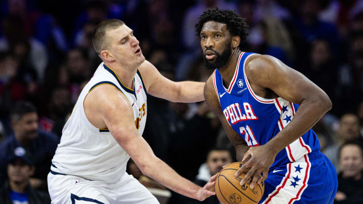 Jan 16, 2024; Philadelphia, Pennsylvania, USA; Philadelphia 76ers center Joel Embiid (21) controls the ball against Denver Nuggets center Nikola Jokic (15) during the first quarter at Wells Fargo Center. Mandatory Credit: Bill Streicher-USA TODAY Sports