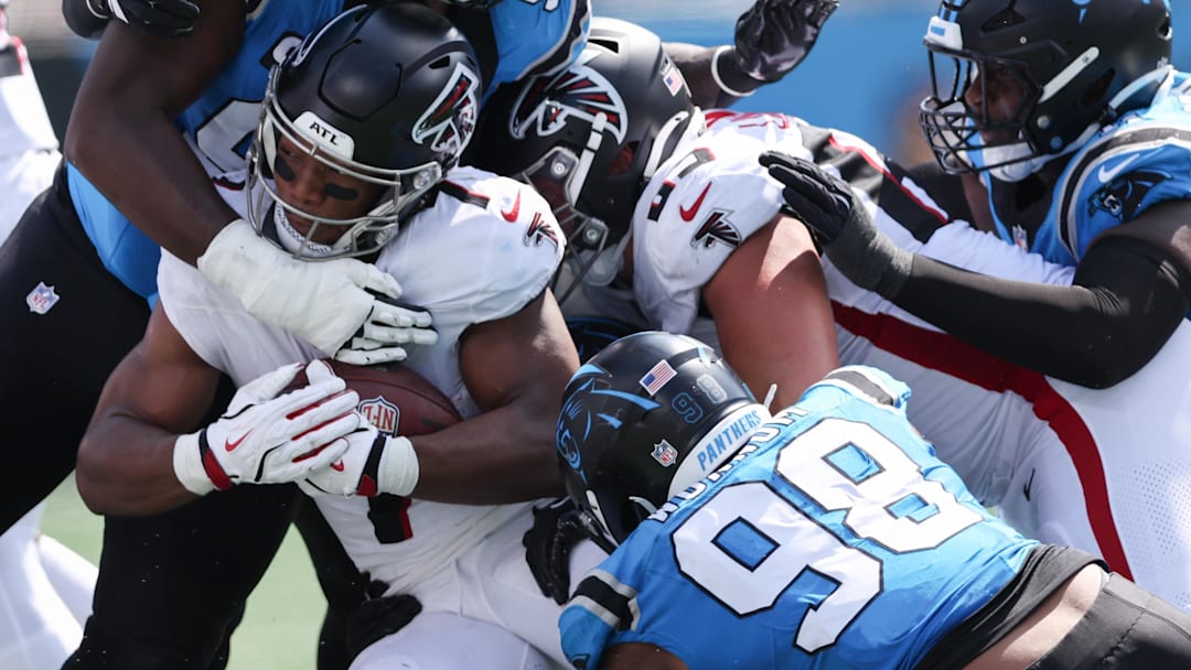 Atlanta Falcons running back Bijan Robinson (7) gets tackled by Carolina Panthers linebacker D.J. Wonnum (98) 