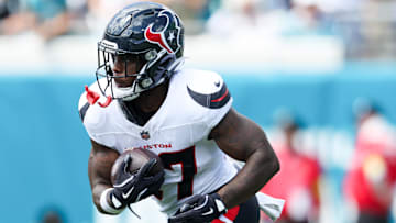 Sep 21, 2025; Jacksonville, Florida, USA; Houston Texans cornerback Myles Bryant (27) runs with the ball during the second quarter against the Jacksonville Jaguars at EverBank Stadium. Mandatory Credit: Morgan Tencza-Imagn Images