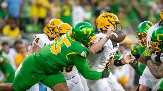 Oregon Ducks defensive lineman Derrick Harmon forces a fumble from Idaho Vandals quarterback Jack Layne