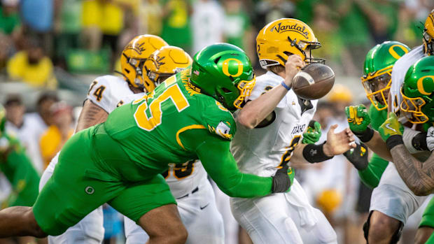 Oregon Ducks defensive lineman Derrick Harmon forces a fumble from Idaho Vandals quarterback Jack Layne 