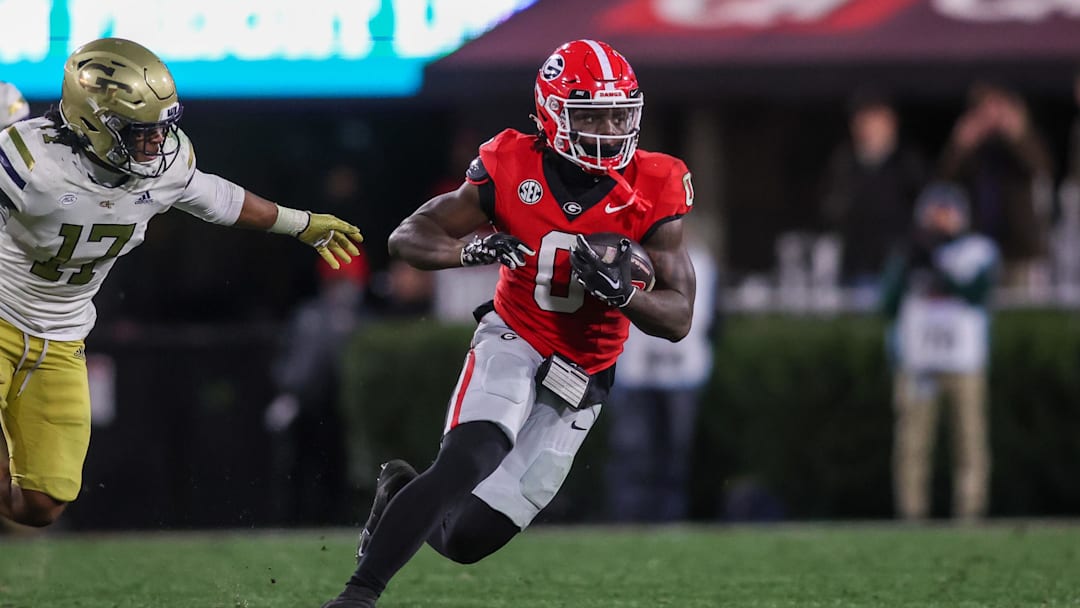 Nov 29, 2024; Athens, Georgia, USA; Georgia Bulldogs running back Roderick Robinson II (0) runs the ball against the Georgia Tech Yellow Jackets in the fourth quarter at Sanford Stadium. Mandatory Credit: Brett Davis-Imagn Images
