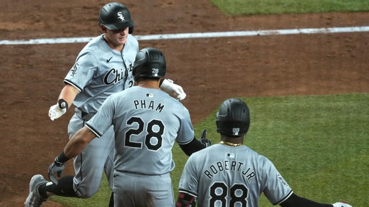 Jun 15, 2024; Phoenix, Arizona, USA; Chicago White Sox first base Andrew Vaughn (25) slaps hands with Chicago White Sox outfielder Tommy Pham (28) and Chicago White Sox outfielder Luis Robert Jr. (88) after hitting a three run home run against the Arizona Diamondbacks during the fifth inning at Chase Field. Mandatory Credit: Joe Camporeale-USA TODAY Sports