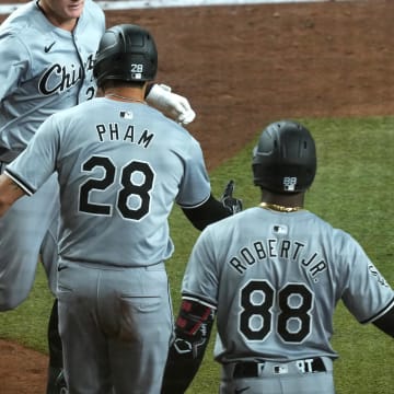 Jun 15, 2024; Phoenix, Arizona, USA; Chicago White Sox first base Andrew Vaughn (25) slaps hands with Chicago White Sox outfielder Tommy Pham (28) and Chicago White Sox outfielder Luis Robert Jr. (88) after hitting a three run home run against the Arizona Diamondbacks during the fifth inning at Chase Field. Mandatory Credit: Joe Camporeale-USA TODAY Sports