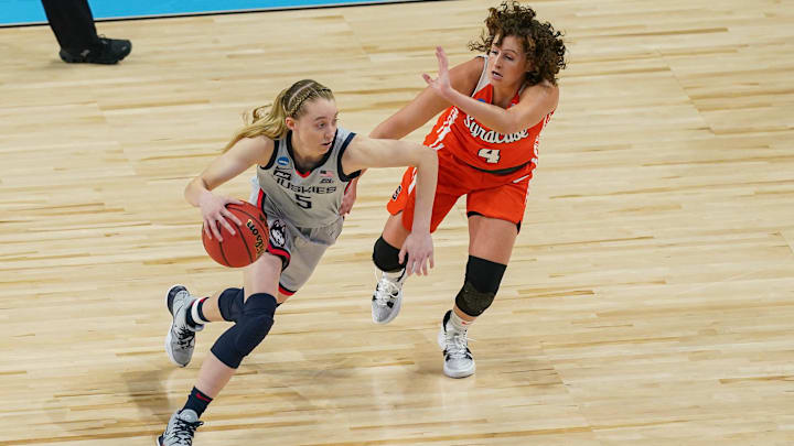 UConn Huskies guard Paige Bueckers (5) drives past Syracuse Orange guard Tiana Mangakahia (4) in the first half at the Alamodome on March 23, 2021. UConn Huskies guard Paige Bueckers (5) drives past Syracuse Orange guard Tiana Mangakahia (4) in the first half at the Alamodome on March 23, 2021.