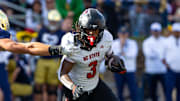 Oct 11, 2025; South Bend, Indiana, USA; NC State Wolfpack running back Hollywood Smothers (3) tries to break a tackle attempt by Notre Dame Fighting Irish linebacker Joshua Burnham (40) during the first half at Notre Dame Stadium. Mandatory Credit: Michael Caterina-Imagn Images