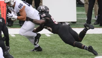 Brenton Strange of Penn State is tackled by Mohamed Toure of Rutgers.