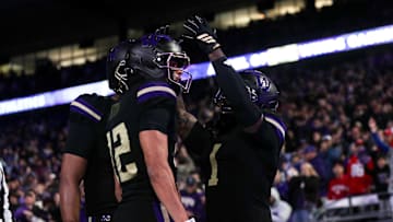 Oct 10, 2025; Seattle, Washington, USA; Washington running back Jonah Coleman (1) puts an imaginary crown on wide receiver Denzel Boston (12) to celebrate a touchdown against the Rutgers Scarlet Knights during the first half at Husky Stadium. Mandatory Credit: Kevin Ng-Imagn Images