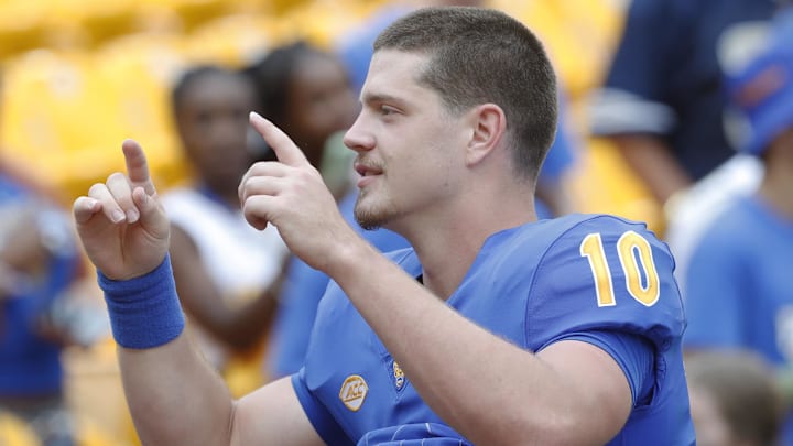 Aug 31, 2024; Pittsburgh, Pennsylvania, USA;  Pittsburgh Panthers quarterback Eli Holstein (10) leads the band in the playing of the PITT Alma Mater after defeating the Kent State Golden Flashes at Acrisure Stadium. Pittsburgh won 55-24.Mandatory Credit: Charles LeClaire-Imagn Images