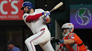 May 15, 2025; Arlington, Texas, USA; Texas Rangers first baseman Jake Burger (21) hits a single during the eighth inning against the Houston Astros at Globe Life Field. 