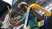 Mar 10, 2024; Greensboro, NC, USA; Notre Dame Fighting Irish head coach Niele Ivey displays the tournament net after defeating the NC State Wolfpack at Greensboro Coliseum. \
