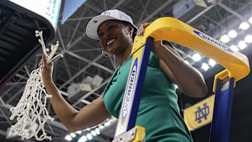 Mar 10, 2024; Greensboro, NC, USA; Notre Dame Fighting Irish head coach Niele Ivey displays the tournament net after defeating the NC State Wolfpack at Greensboro Coliseum. \