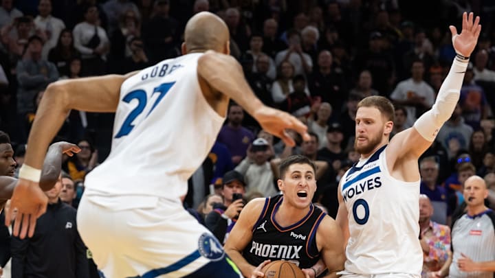 Phoenix Suns guard Collin Gillespie (12) prepares to take the game winning shot against Minnesota Timberwolves guard Donte DiVincenzo (0) in the second half of an NBA Cup game at Mortgage Matchup Center. Mandatory Credit: Mark J. Rebilas-Imagn Images