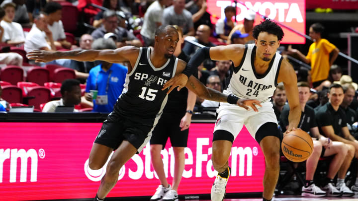 Jul 13, 2024; Las Vegas, NV, USA; Portland Trail Blazers forward Justin Minaya (24) dribbles against San Antonio Spurs guard Jamaree Bouyea (15) during the fourth quarter at Thomas & Mack Center. Mandatory Credit: Stephen R. Sylvanie-USA TODAY Sports