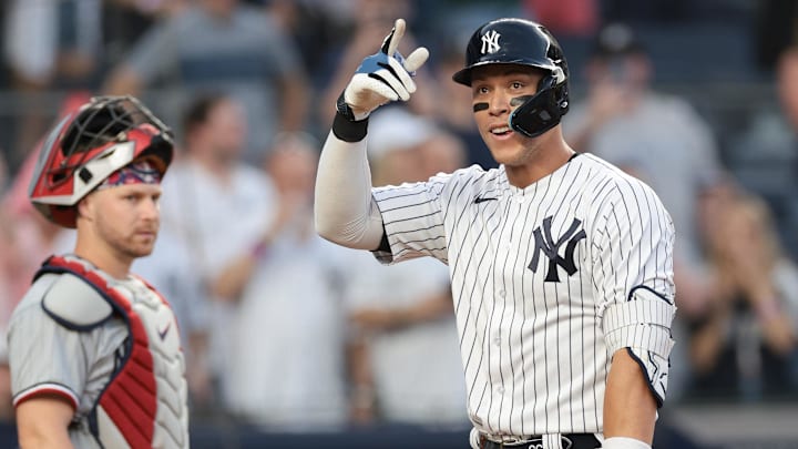 Apr 14, 2023; Bronx, New York, USA; New York Yankees right fielder Aaron Judge (99) reacts after hitting a solo home run during the first inning in front of Minnesota Twins catcher Ryan Jeffers (27) at Yankee Stadium. Mandatory Credit: Vincent Carchietta-Imagn Images