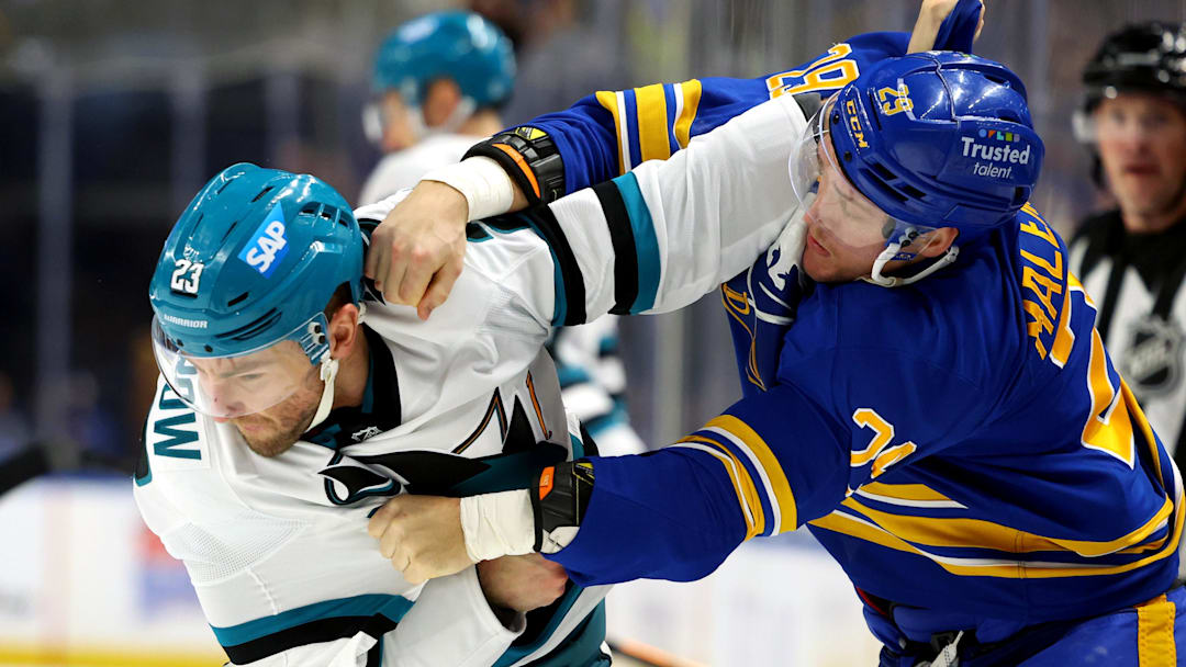 Mar 10, 2026; Buffalo, New York, USA;  San Jose Sharks center Barclay Goodrow (23) and Buffalo Sabres left wing Beck Malenstyn (29) fight during the first period at KeyBank Center. Mandatory Credit: Timothy T. Ludwig-Imagn Images