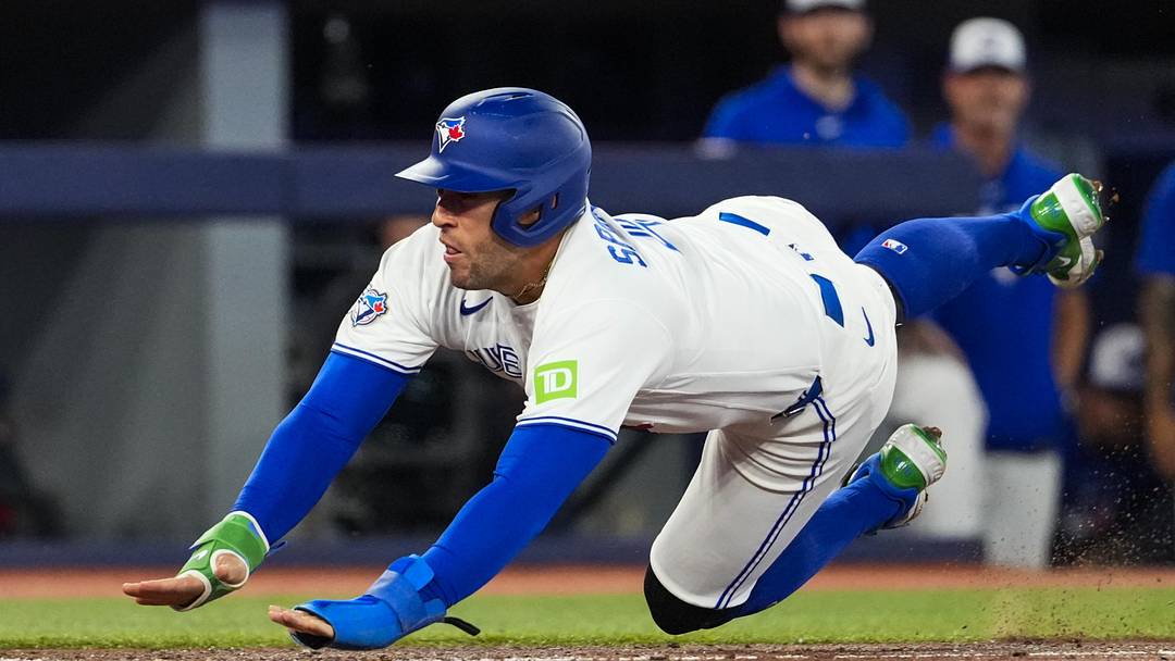 Jun 10, 2026; Toronto, Ontario, CAN;  Toronto Blue Jays designated hitter George Springer (4) slides into home plate during the seventh inning against the Philadelphia Phillies at Rogers Centre. Mandatory Credit: Kevin Sousa-Imagn Images